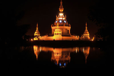 Reflection of illuminated building in water at night