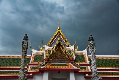 Low angle view of temple building against cloudy sky