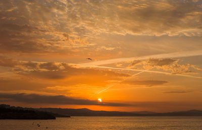 Scenic view of sea against orange sky