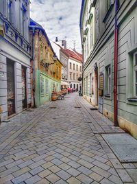 Empty alley amidst buildings in city