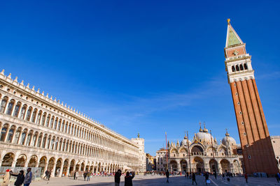 Group of people in front of historical building against sky