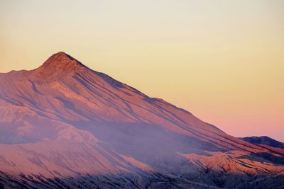 Scenic view of snowcapped mountains against sky during sunset