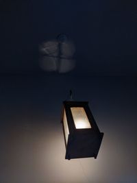 Low angle view of illuminated lamp against sky at night