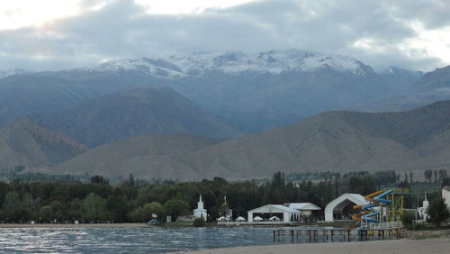 Scenic view of lake and mountains against sky