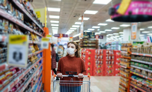 Woman wearing mask shopping at mall