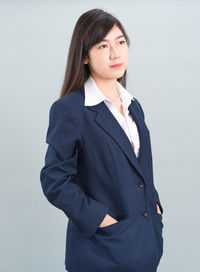 Portrait of a smiling young woman against white background