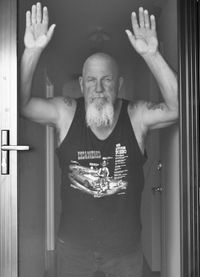 Portrait of man standing at home