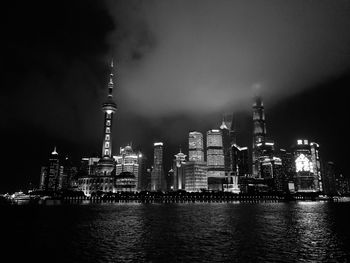 Illuminated city against sky at night