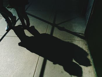 Low section of people standing on tiled floor