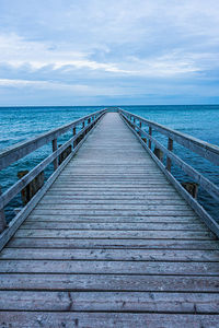 Pier over sea against sky