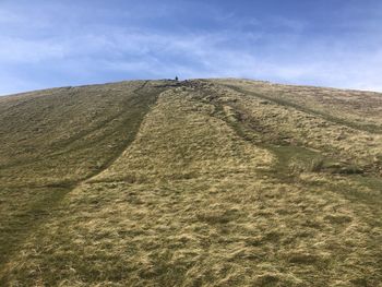 Low angle view of arid landscape against sky