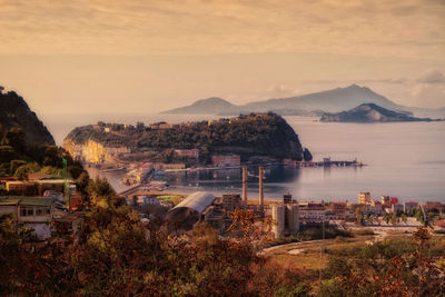 Panoramic shot of townscape by sea against sky