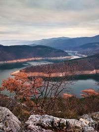 Scenic view of lake and mountains against sky