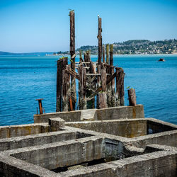 Abandoned built structure by sea against sky