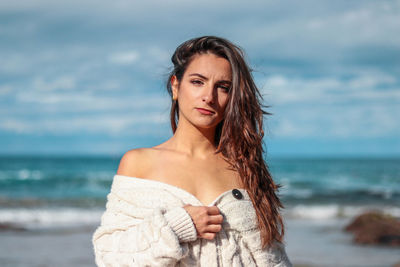 Young woman standing at beach