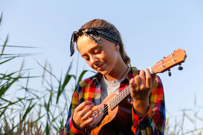 Young woman playing guitar