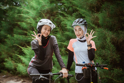 Portrait of smiling females on bicycle