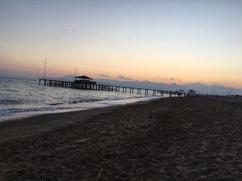 Scenic view of beach against sky during sunset