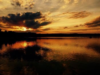 Scenic view of lake against romantic sky at sunset