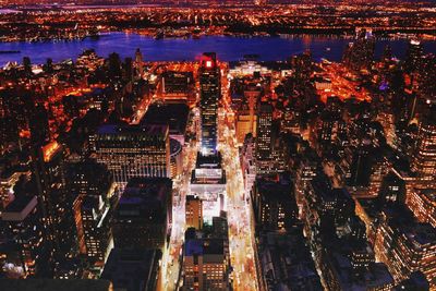 Aerial view of city lit up at night
