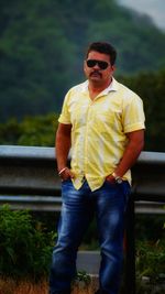 Young man wearing sunglasses standing outdoors