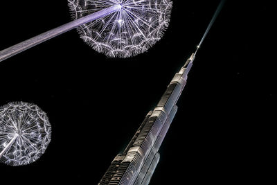 Low angle view of illuminated fireworks against sky at night