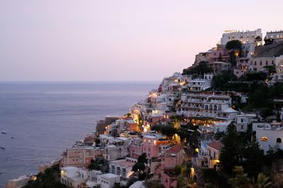 High angle view of townscape by sea against sky