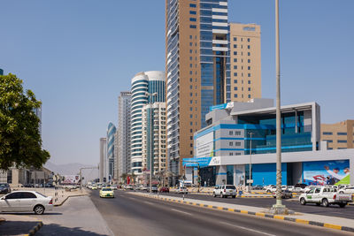 City street and modern buildings against clear blue sky