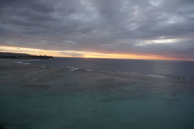 Scenic view of beach against sky during sunset