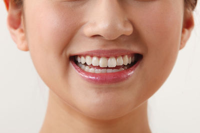 Close-up of smiling woman over white background