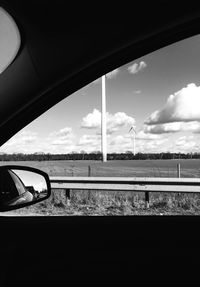 Reflection of sky on side-view mirror of car