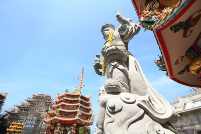 Low angle view of statue against sky