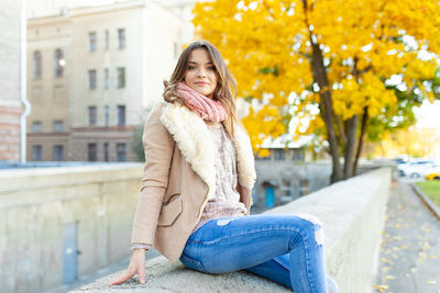 Smiling beautiful woman sitting in city