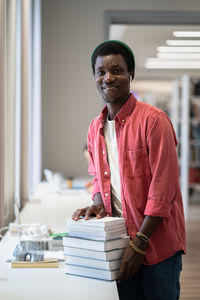 Side view of young man sitting on table