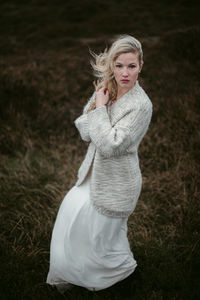 Portrait of woman standing on field