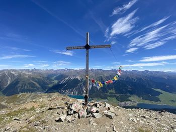 Wind turbines on mountain against sky