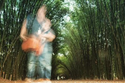 Blurred motion of man in forest