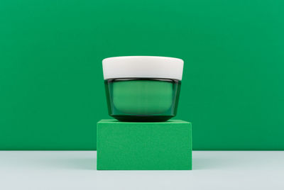 Close-up of toy on table against green background