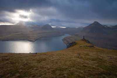 Scenic view of land and mountains against sky