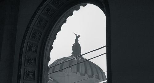 Low angle view of statue against historic building