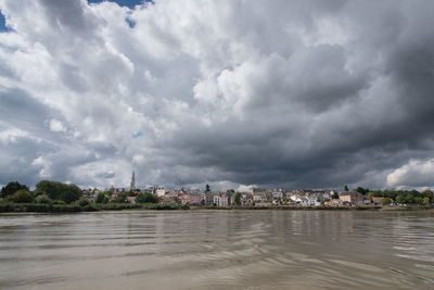 Scenic view of sea and buildings against sky