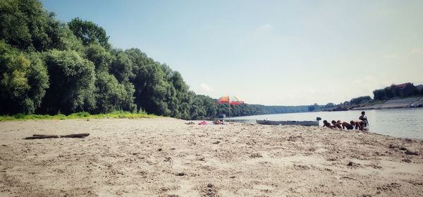 People on beach against sky