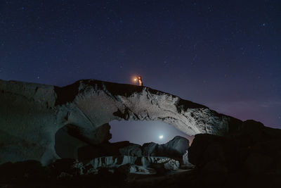 View of illuminated snowcapped mountains against sky at night