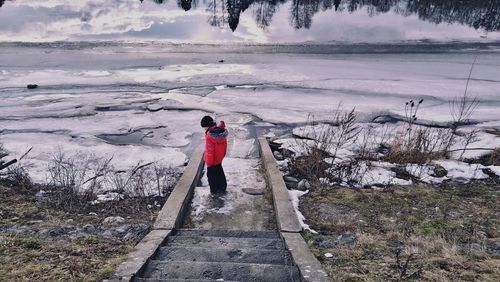 Rear view of person standing in snow