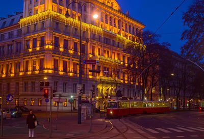 Illuminated city against sky at night