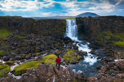 Scenic view of waterfall against sky