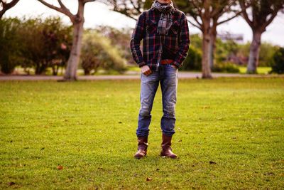 Low section of man standing on field