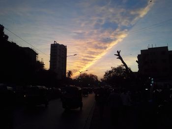 Buildings in city at sunset