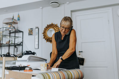 Side view of woman exercising at home