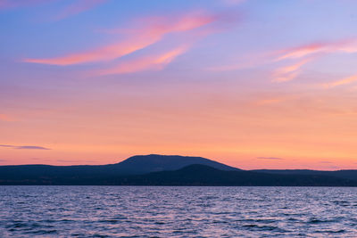 Scenic view of sea against romantic sky at sunset